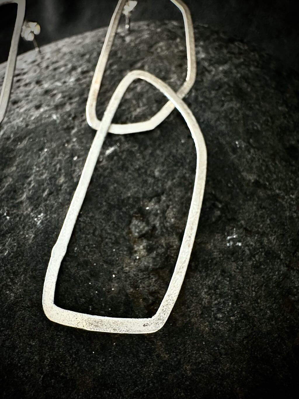 Close-up of a brushed silver link with a poinçon de maître hallmark
