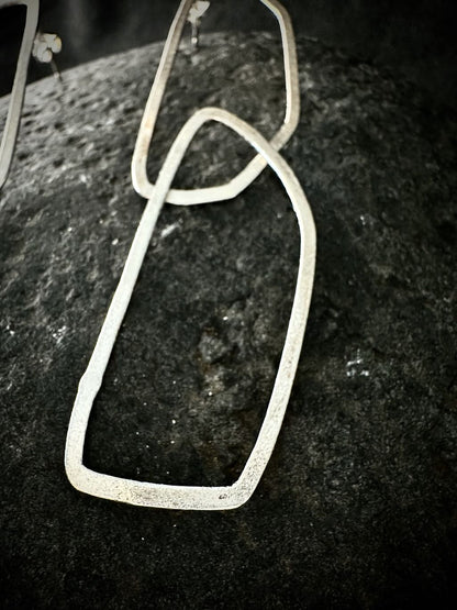 Close-up of a brushed silver link with a poinçon de maître hallmark