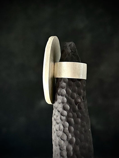 Side profile of handmade silver statement ring showing wide flat band