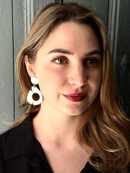 Sculptural silver hoop drop earrings worn on model. Recycled sterling silver, ca 62mm drop, handmade organic form, one of a kind.