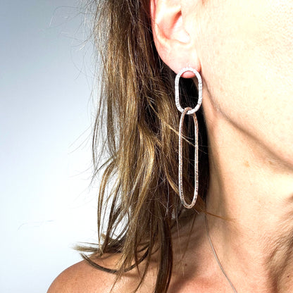 long oval dangly silver earrings in hammered structure