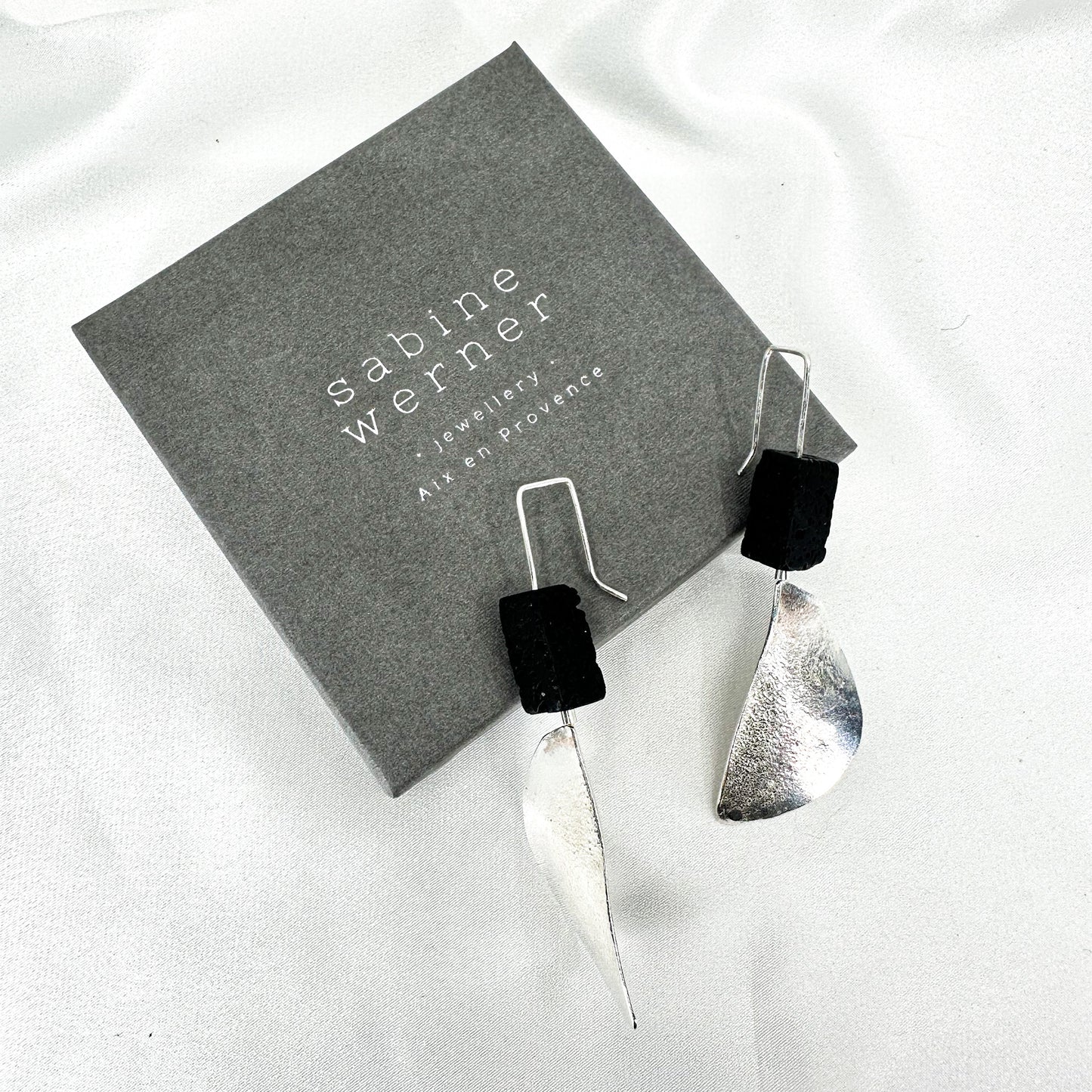 long dangly silver earrings with black lava stone