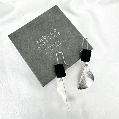 long dangly silver earrings with black lava stone