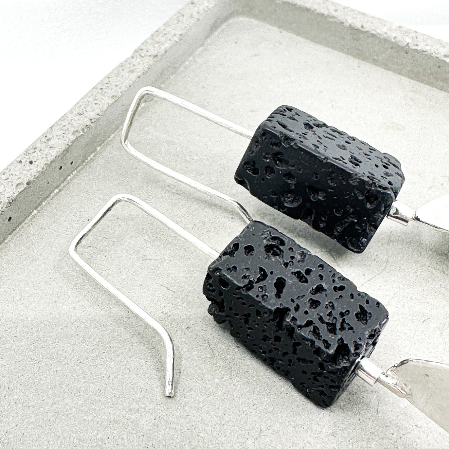 long dangly silver earrings with black lava stone