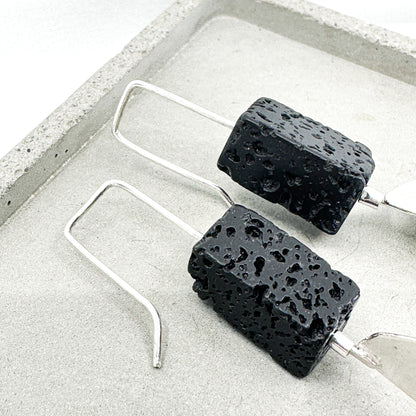 long dangly silver earrings with black lava stone