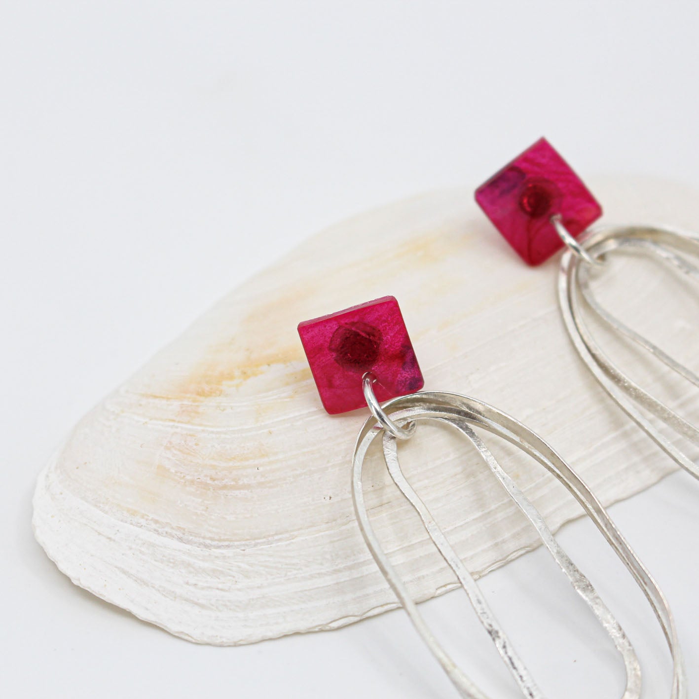 long oval dangly silver earrings with pink resin square top
