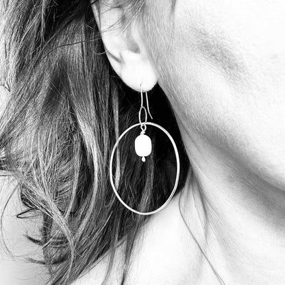 Large handmade silver hoop earrings with baroque pearl drop – minimalist sculptural jewellery by Sabine Werner