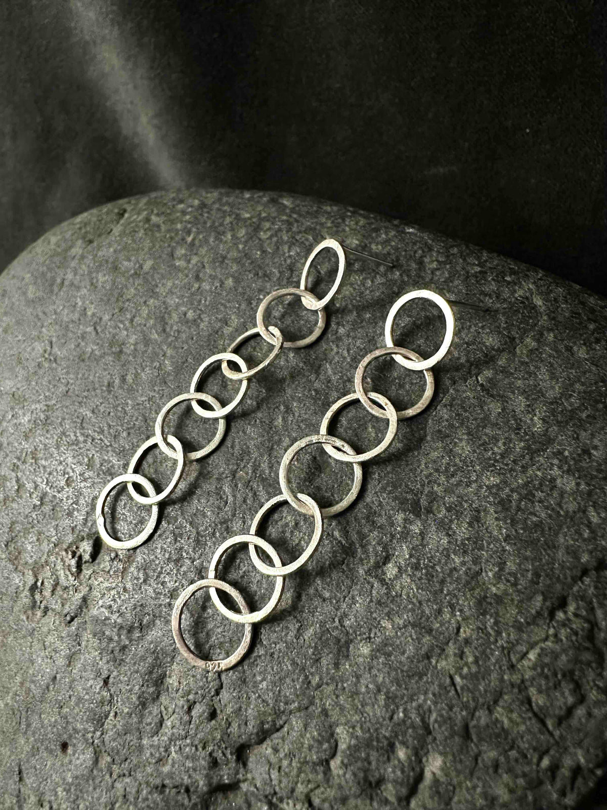 Two silver chain drop earrings side by side, full length view