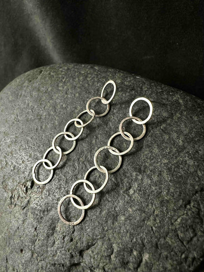 Two silver chain drop earrings side by side, full length view