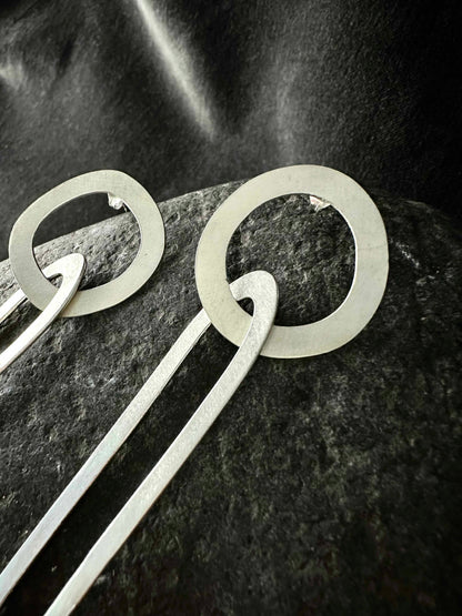 Detail of an organic circle stud interlocking with an oval link, recycled 925 silver