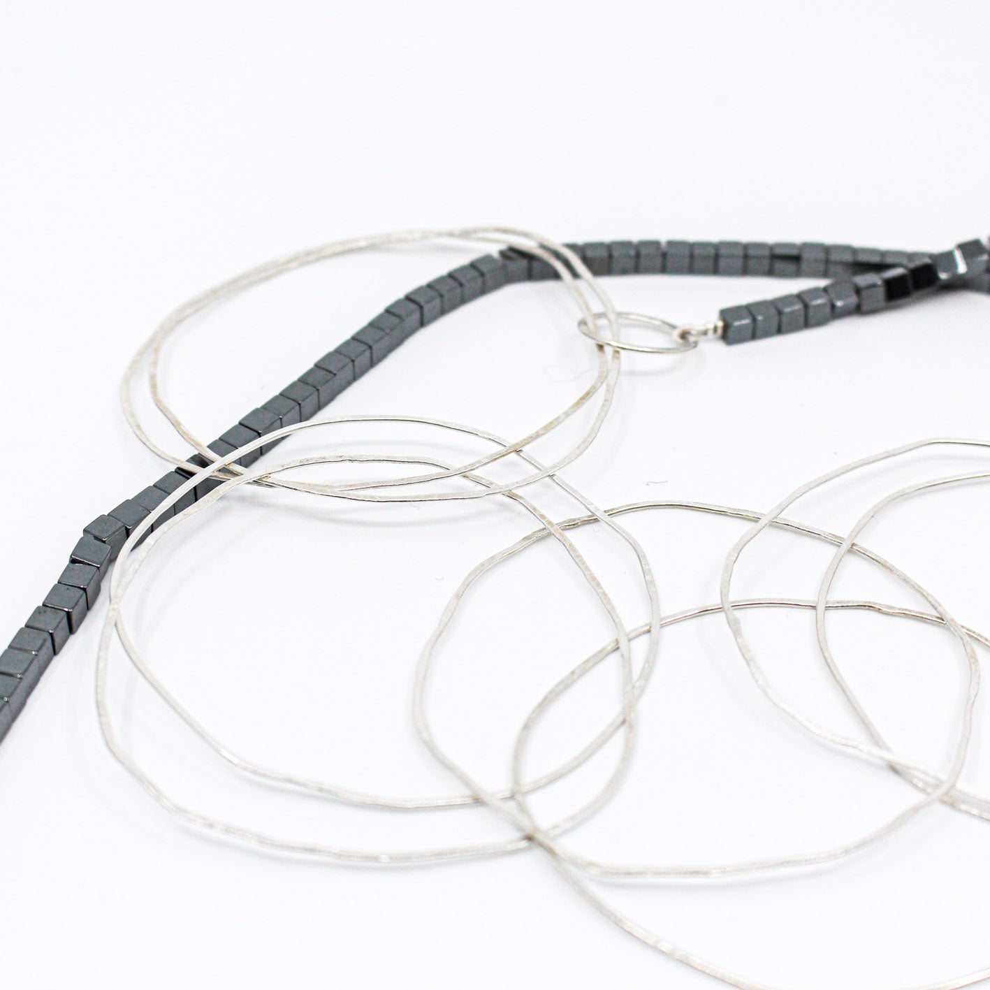 extra long minimalist statement necklace with hematite cubes and sterling silver rings
