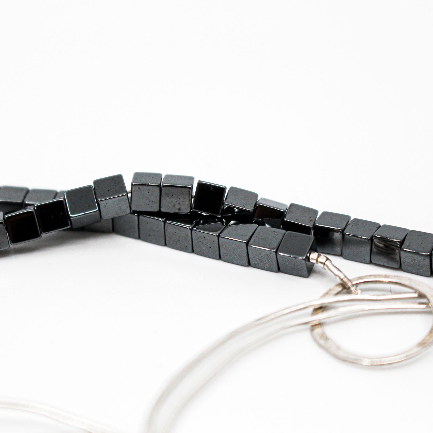 extra long minimalist statement necklace with hematite cubes and sterling silver rings