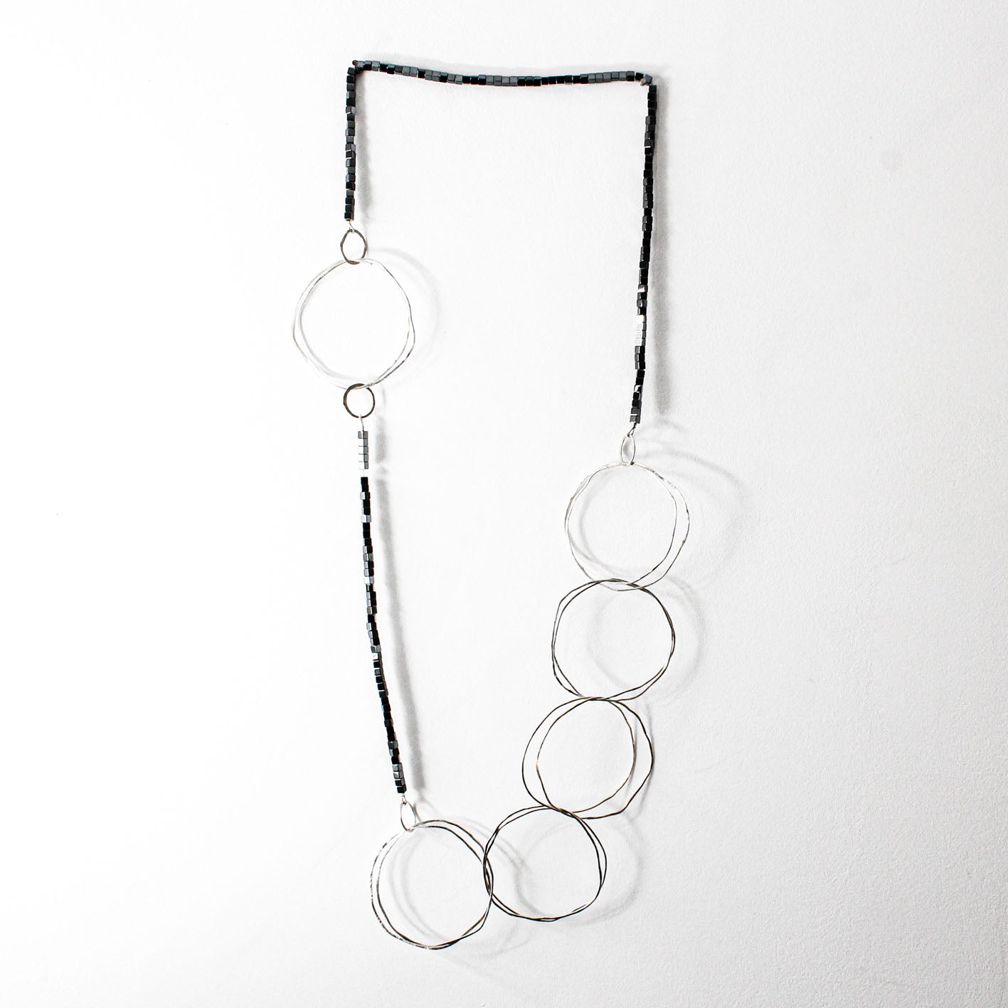 extra long minimalist statement necklace with hematite cubes and sterling silver rings