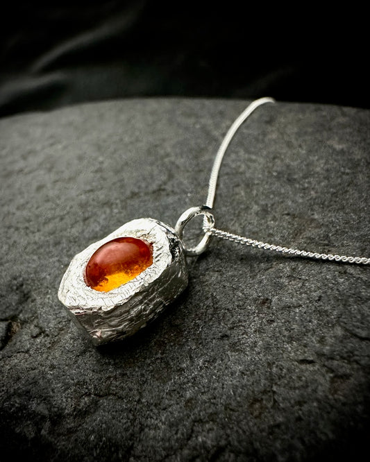 Handmade sterling silver amber pendant necklace with textured organic silver setting