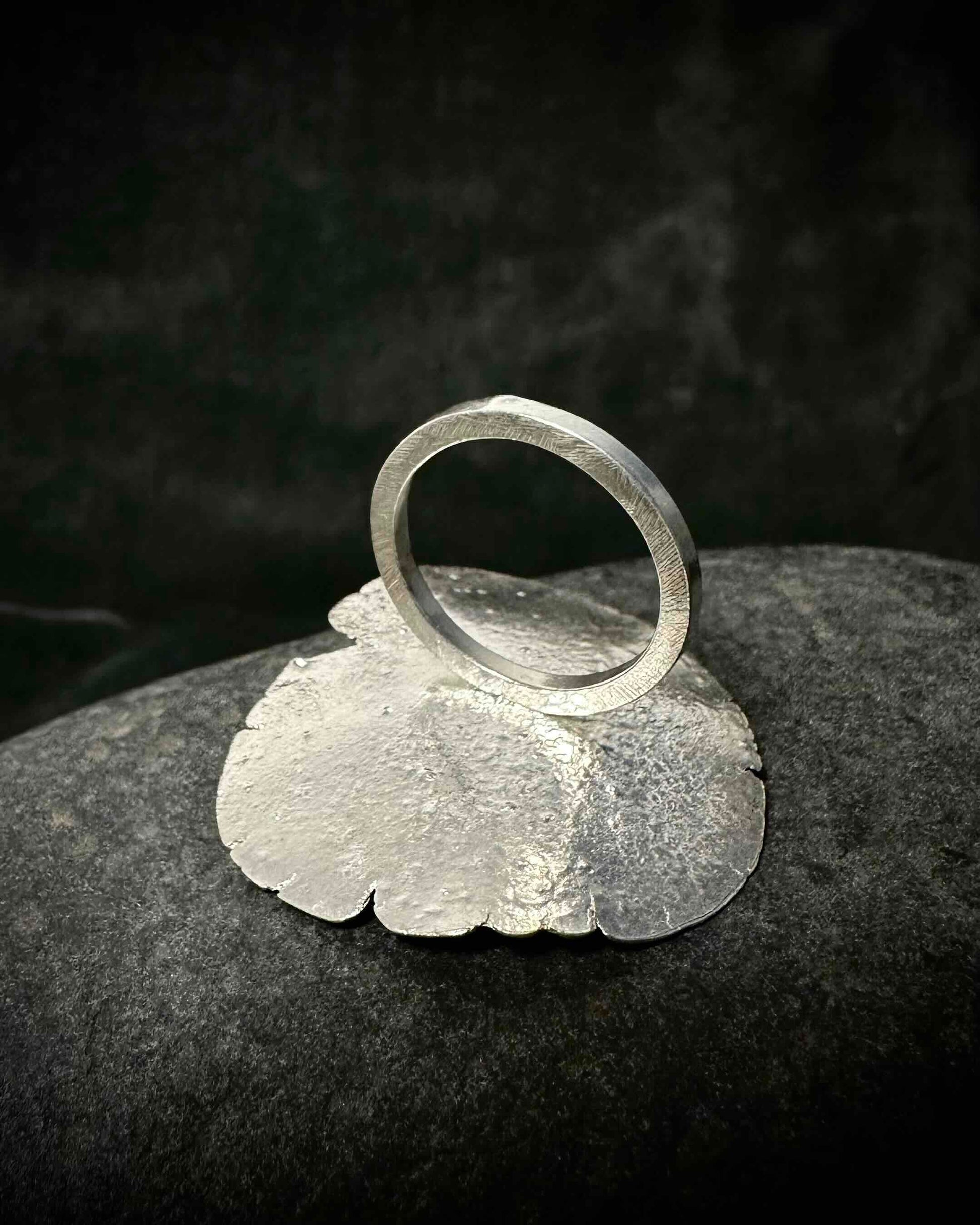 Close-up of back of  blue topaz in handmade recycled sterling silver ring