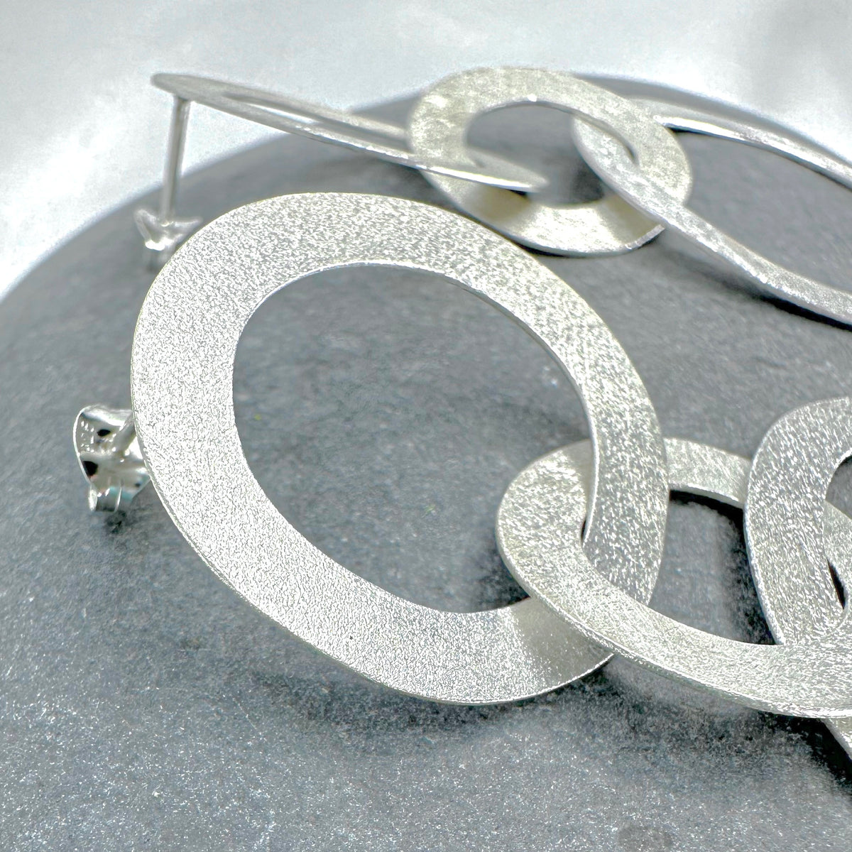 Sterling silver double circle earrings close-up - brushed finish detail