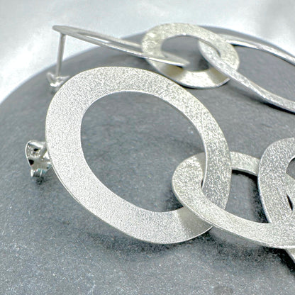Sterling silver double circle earrings close-up - brushed finish detail