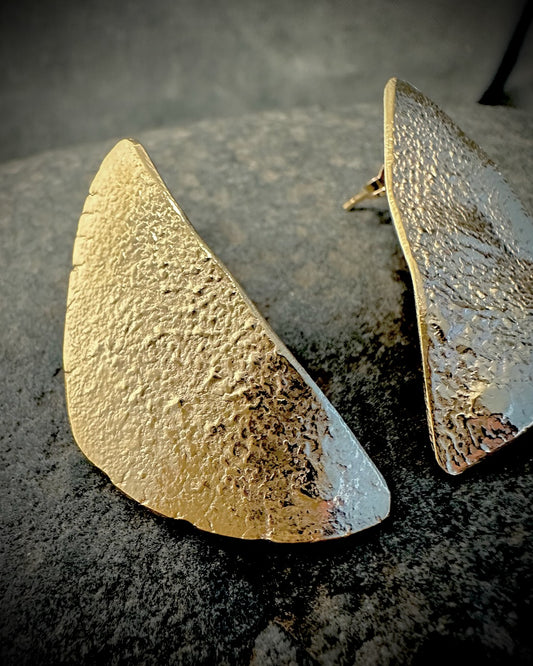 Textured gold plated half moon stud earrings in recycled sterling silver on dark background