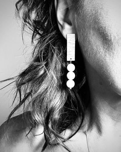 Hammered sterling silver earrings with natural jade beads worn by model