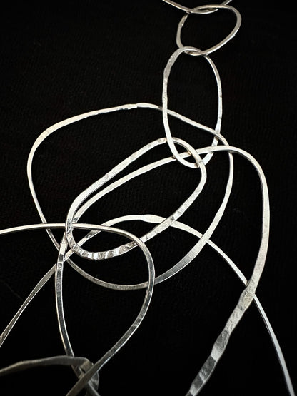 Detail of hammered sterling silver loops in sculptural necklace