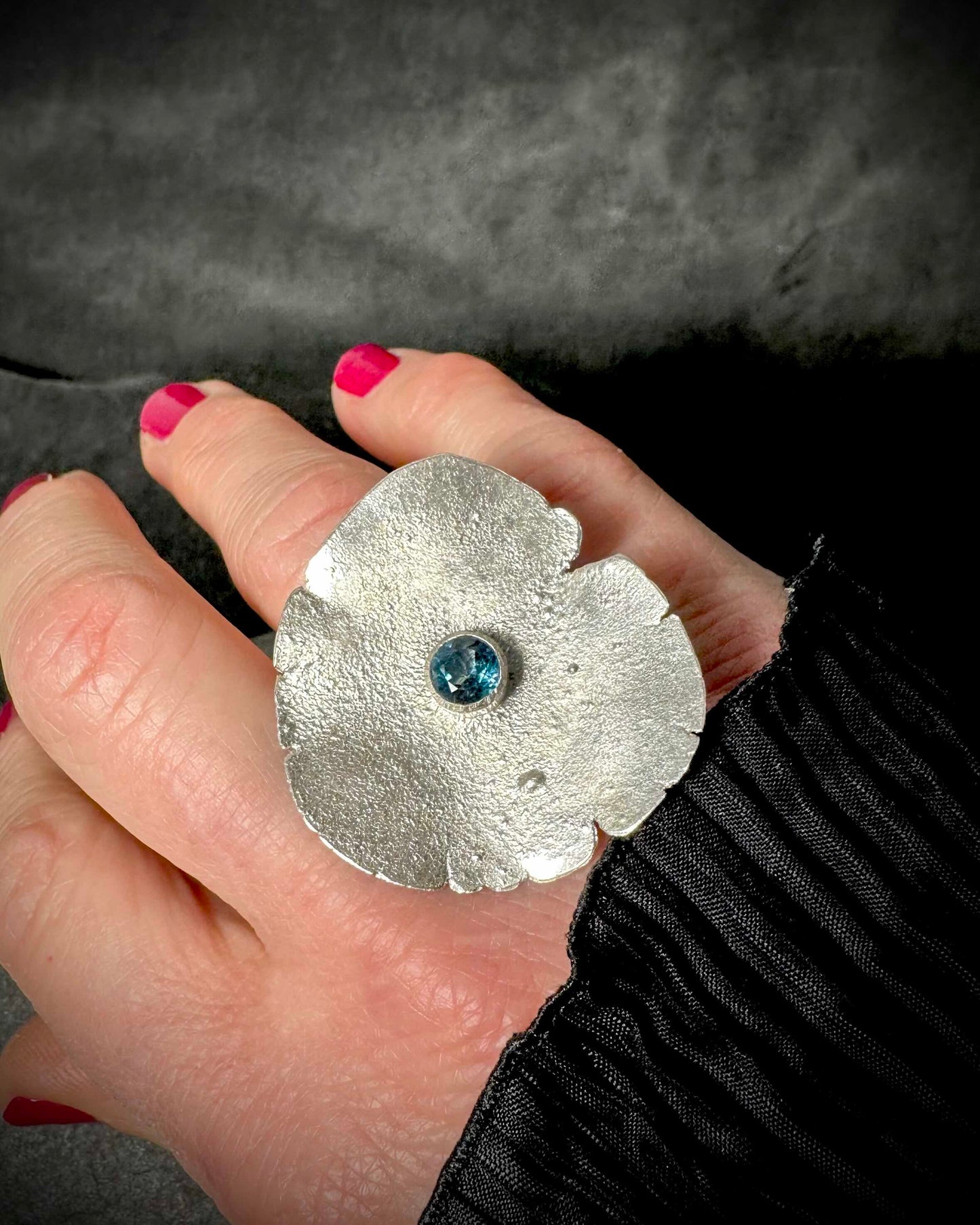 One-of-a-kind large sterling silver ring with blue topaz worn on hand, statement jewellery