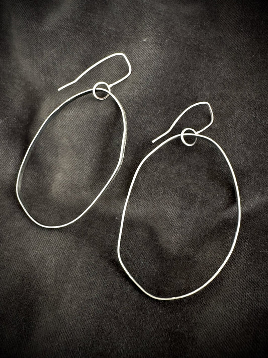 Oxidised silver drop hoop earrings on dark fabric - handmade organic hoops
