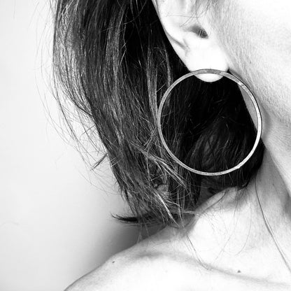 Woman wearing oxidised silver hoop earring - blackened handmade hoop