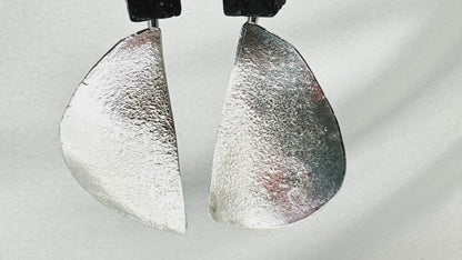 long dangly silver earrings with black lava stone