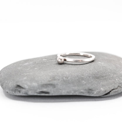 five simple silver stacking rings each with a textured sterling silver drop