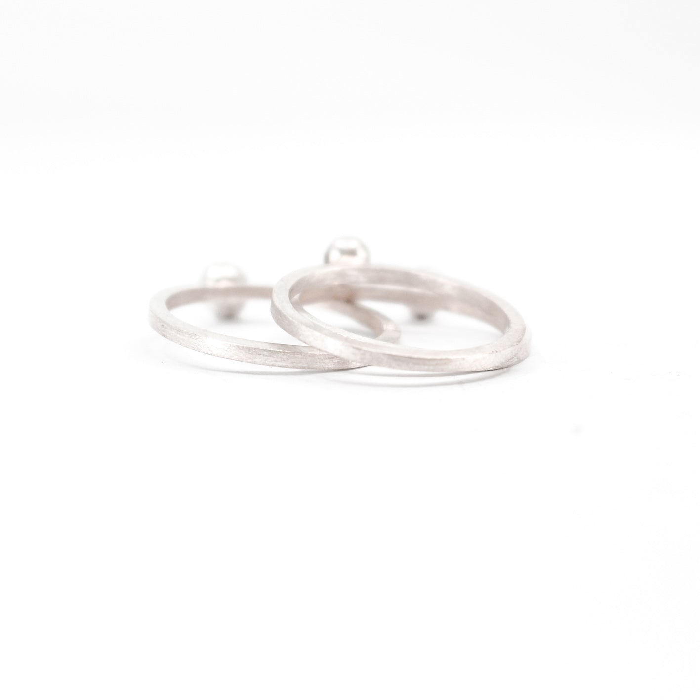three simple silver stacking rings with each a set black diamond