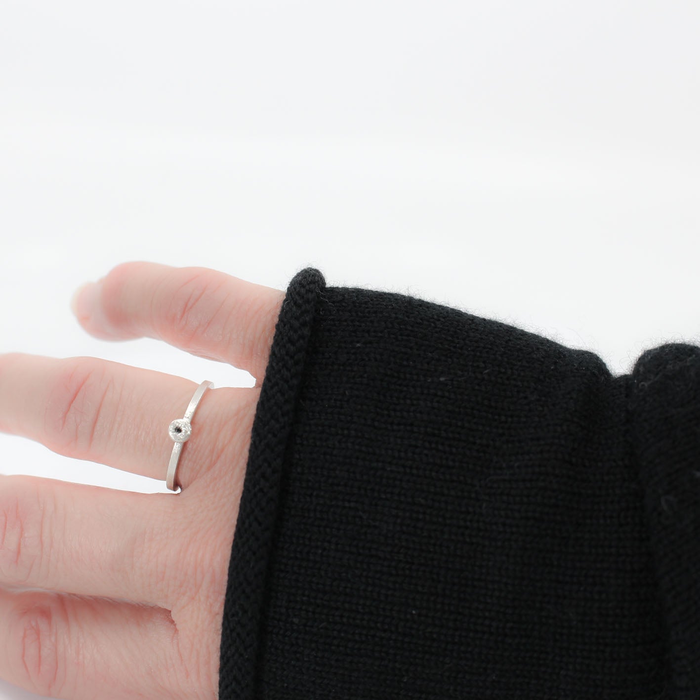 three simple silver stacking rings with each a set black diamond