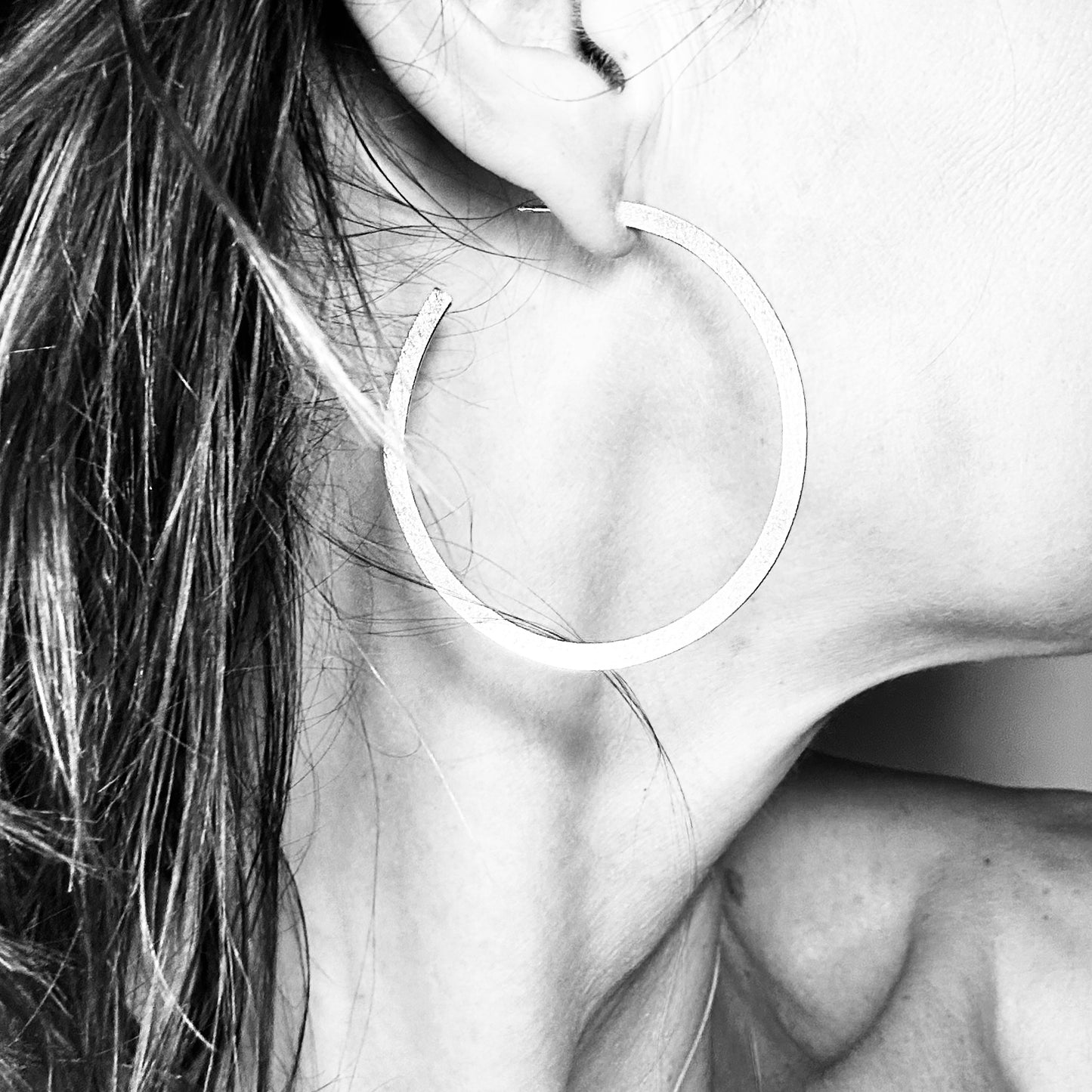 Sterling silver hoop earring worn close-up - handmade round hoops