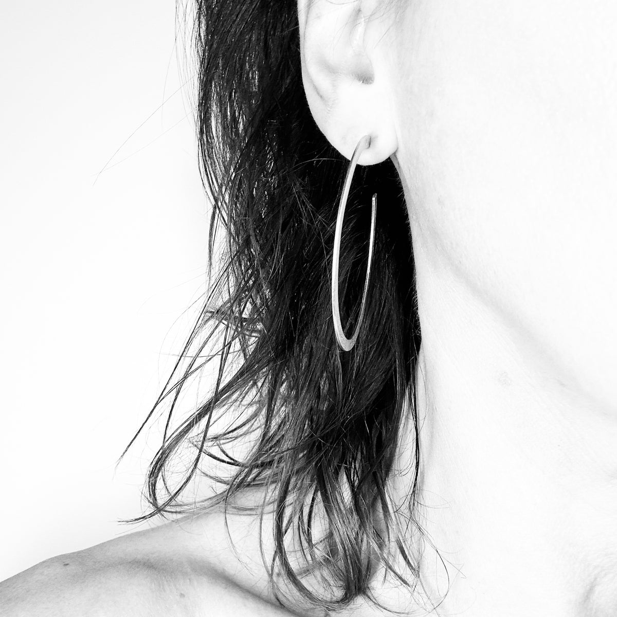 Sterling silver hoop earring worn close-up - handmade round hoops