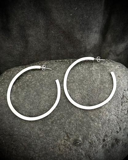 Long sterling silver hoop earrings on dark stone - handmade minimalist jewelry