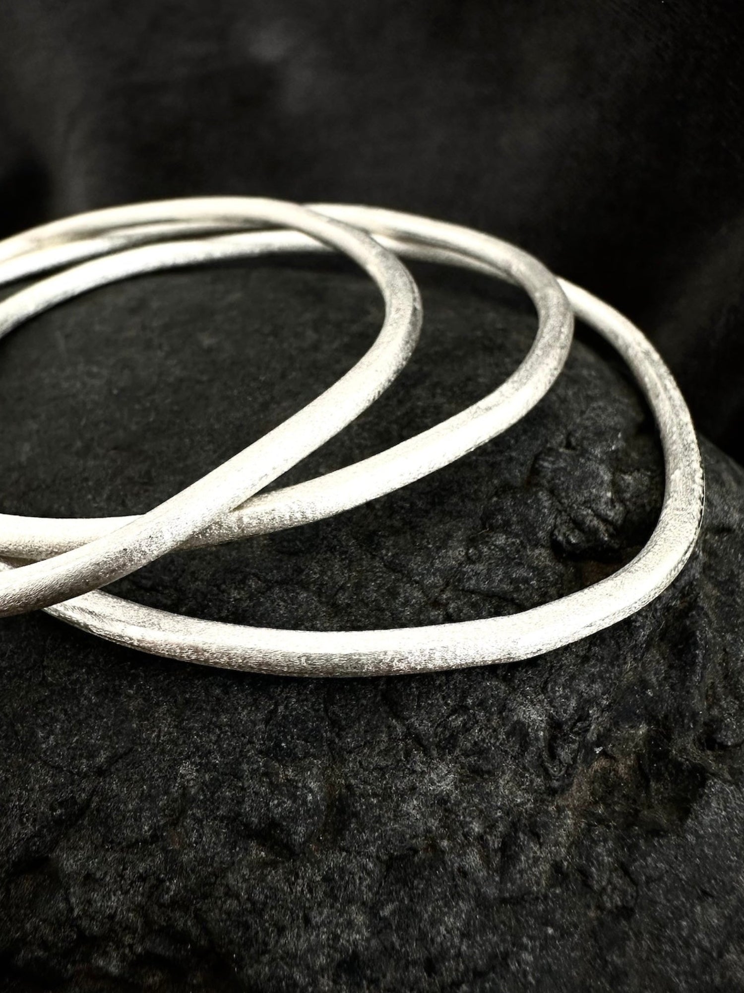Sterling silver stackable bangles close-up - hammered texture detail