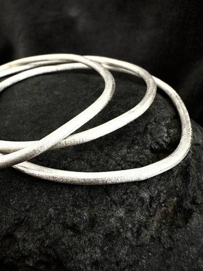 Sterling silver stackable bangles close-up - hammered texture detail