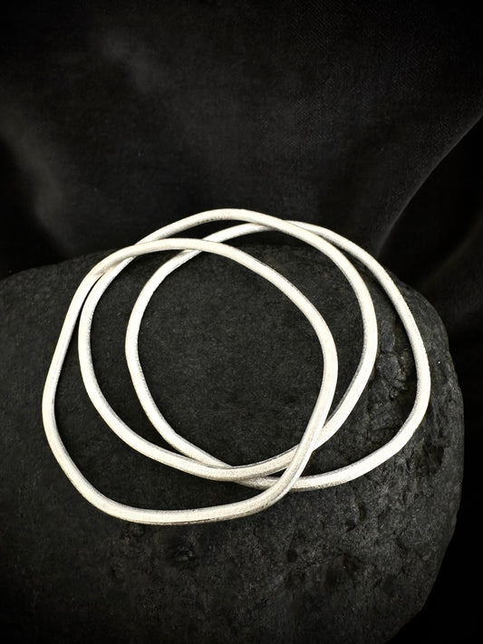 Set of 3 sterling silver stackable bangles on stone - handmade textured bracelets