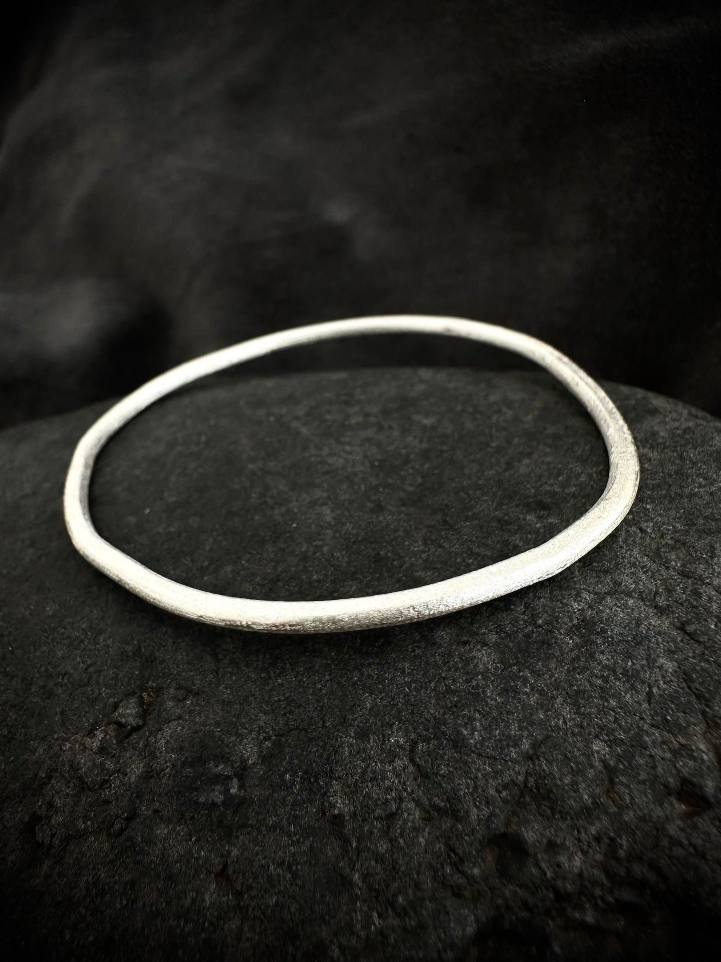 Single sterling silver bangle on stone - handmade round bracelet