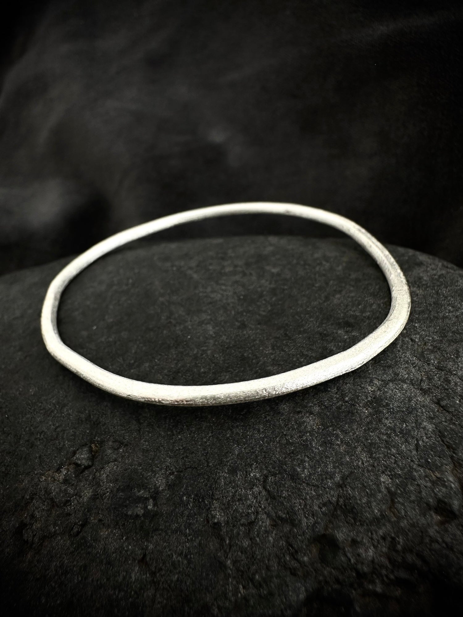 Single sterling silver bangle on stone - handmade round bracelet