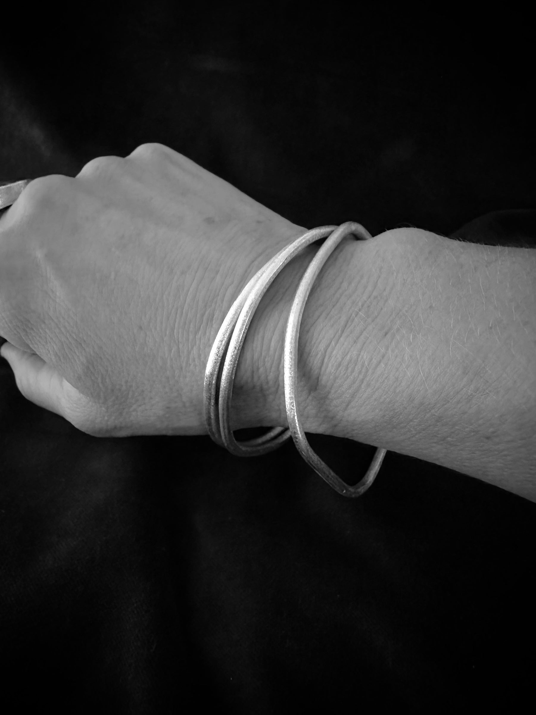 Set of 3 sterling silver bangles worn on wrist - stackable minimalist bracelets